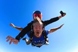 Tandem skydiving above the New York coastline.